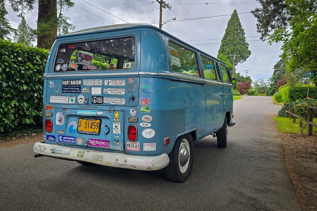 Harry Danberg’s 1970 Volkswagen Kombi wears decades of personality on its decal-covered lift gate; (